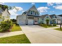 Gray house with white garage doors and pink front door at 368 Trailmore Ln, Summerville, SC 29486