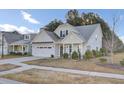Craftsman style home with white siding, gray roof and landscaping at 373 Whispering Breeze Ln, Summerville, SC 29486