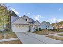 White two-story house with a gray roof and a two-car garage at 373 Whispering Breeze Ln, Summerville, SC 29486