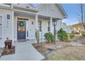 Front entry with gray door, white columns and landscaping at 373 Whispering Breeze Ln, Summerville, SC 29486