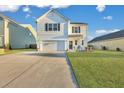Two-story white house with a green door, landscaping, and a two-car garage at 432 Eva St, Moncks Corner, SC 29461