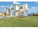 Two-story white house with a green door, landscaping, and a two-car garage at 432 Eva St, Moncks Corner, SC 29461