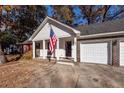 Front view of a two-story home with white siding and a brick facade at 107 Deer Run Ct, Goose Creek, SC 29445