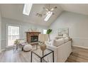 Spacious living room with vaulted ceiling, fireplace, and skylights at 152 Hickory Trace Dr, Goose Creek, SC 29445