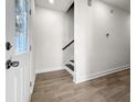 Bright entryway with wood-look flooring and stairs leading to the second floor at 2042 Delaware Ave, North Charleston, SC 29405