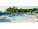 Community pool with splash features and lounge chairs at 517 Rustling Tree Ct, Summerville, SC 29486