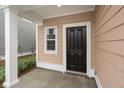 Covered front porch with black front door, and a window beside it at 771 Opal Wing St, Moncks Corner, SC 29461