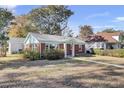 Inviting brick house with a teal front door and a landscaped front yard at 1001 Lango Ave, Charleston, SC 29407