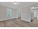 Bright living room with wood-look flooring, neutral paint, and multiple windows at 2675 Houston St, North Charleston, SC 29405