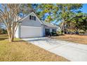 Front exterior view of home with driveway, attached garage, and landscaping at 2775 Palmetto Hall Blvd, Mount Pleasant, SC 29466