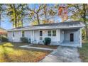 Single-story home with updated gray painted brick and white covered porch at 3 Summit Ave, Goose Creek, SC 29445