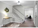 Bright entryway with hardwood floors, staircase, and a console table at 106 Inwood Dr, Summerville, SC 29485