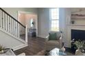 Cozy living room with a fireplace, comfy seating, and view of the foyer at 112 Crosscut Ln, Summerville, SC 29486