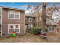 Two-story home with holiday decorations, a small fenced yard, and a large tree at 120 Luden Dr # C, Summerville, SC 29483