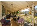 Wooden front porch with seating and views of the yard at 1305 Sandy Run Cir, Summerville, SC 29486