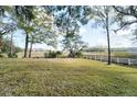 Spacious backyard with marsh views and a white fence at 1755 Markham Rd, Charleston, SC 29414