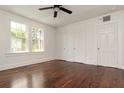 Bright bedroom with polished hardwood floors, white walls, and multiple closets at 1808 Calvert St, North Charleston, SC 29405