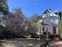 Charming two-story home with blooming magnolia tree in front at 208 Sumter Ave, Summerville, SC 29483