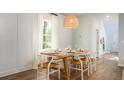 Bright dining room with wood table and chairs, hardwood floors at 302 Tiliwa St, Summerville, SC 29486