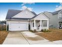 Lovely one-story home with a front porch and attached garage at 356 Garden Lily Ln, Summerville, SC 29485