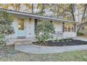 Renovated front entry with a light-blue door and updated landscaping at 402 Corey Blvd, Summerville, SC 29483