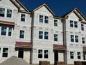 Three story townhome under construction, red roof, and brick accents at 5142 Double Eagle Lp, Summerville, SC 29485