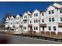 Row of three-story townhomes under construction with red roofs at 5142 Double Eagle Lp, Summerville, SC 29485