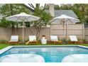 Relaxing pool area with lounge chairs and umbrellas, perfect for summer enjoyment at 523 Reid St, Mount Pleasant, SC 29464