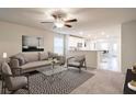 Open living room with neutral walls, comfy seating, and views into the kitchen at 762 Meadowbrook Ln, Summerville, SC 29486
