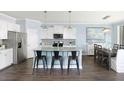 Modern kitchen with white cabinets, granite countertops, and a large island at 147 Royal Cainhoy Way, Huger, SC 29450