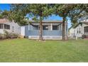 Charming blue house with a covered porch and large trees at 2265 Bailey Dr, North Charleston, SC 29405