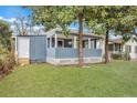 Gray house with a porch, white door, and a spacious lawn at 2265 Bailey Dr, North Charleston, SC 29405