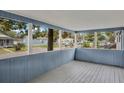 Screened porch with wood flooring and view of the neighborhood at 2265 Bailey Dr, North Charleston, SC 29405