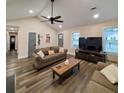 Spacious living room featuring hardwood floors, a large TV, and comfortable seating at 2925 Salamander Creek Ln, North Charleston, SC 29406