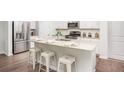 Modern kitchen island with granite countertops and white cabinets at 303 Tiliwa Street, Summerville, SC 29486