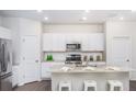 Modern kitchen with white cabinets, granite countertops, and island at 303 Tiliwa Street, Summerville, SC 29486