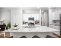 Modern kitchen with white cabinets, granite countertops, and stainless steel appliances at 304 Tiliwa Street, Summerville, SC 29486
