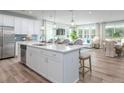 Modern kitchen with white cabinetry, stainless steel appliances, and large island at 310 Quiet Cove Trl, Summerville, SC 29486