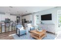 Bright living room featuring light blue walls and comfy seating at 310 Quiet Cove Trl, Summerville, SC 29486
