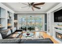 Living room with fireplace, built-in shelves, and view of patio at 311 Bloomington Way, Summerville, SC 29486