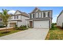 Two-story gray house with white garage door and landscaping at 318 Abercom Place Dr, Moncks Corner, SC 29461