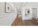 Bright hallway with hardwood floors, shiplap walls, and modern decor at 453 Parish Farms Dr, Summerville, SC 29486