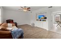 Living room with brown leather couch and built-in shelving at 573 Travelers Blvd, Summerville, SC 29485