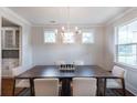 Elegant dining area with a large wooden table and chandelier at 763 Maynard Ln, Summerville, SC 29486