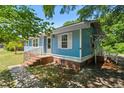 View of the side of the charming light blue house, showing the steps and walkway at 803 Chaplin Street, Walterboro, SC 29488