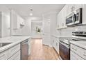 Modern kitchen with white cabinets, quartz countertops, and stainless steel appliances at 929 Long Point Rd, Mount Pleasant, SC 29464