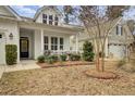 Landscaped front yard with walkway and bird bath, charming home exterior at 1048 Old Field Dr, Summerville, SC 29483