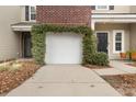 White garage door with lush greenery covering the top at 1819 Heldsberg Dr, Charleston, SC 29414