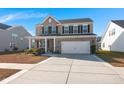 Two-story brick home with a large driveway and landscaped yard at 309 Blue Shadows Ct, Summerville, SC 29486