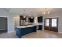 Modern kitchen with dark cabinets, quartz countertops, and stainless steel appliances at 42 Summer Dr, Walterboro, SC 29488